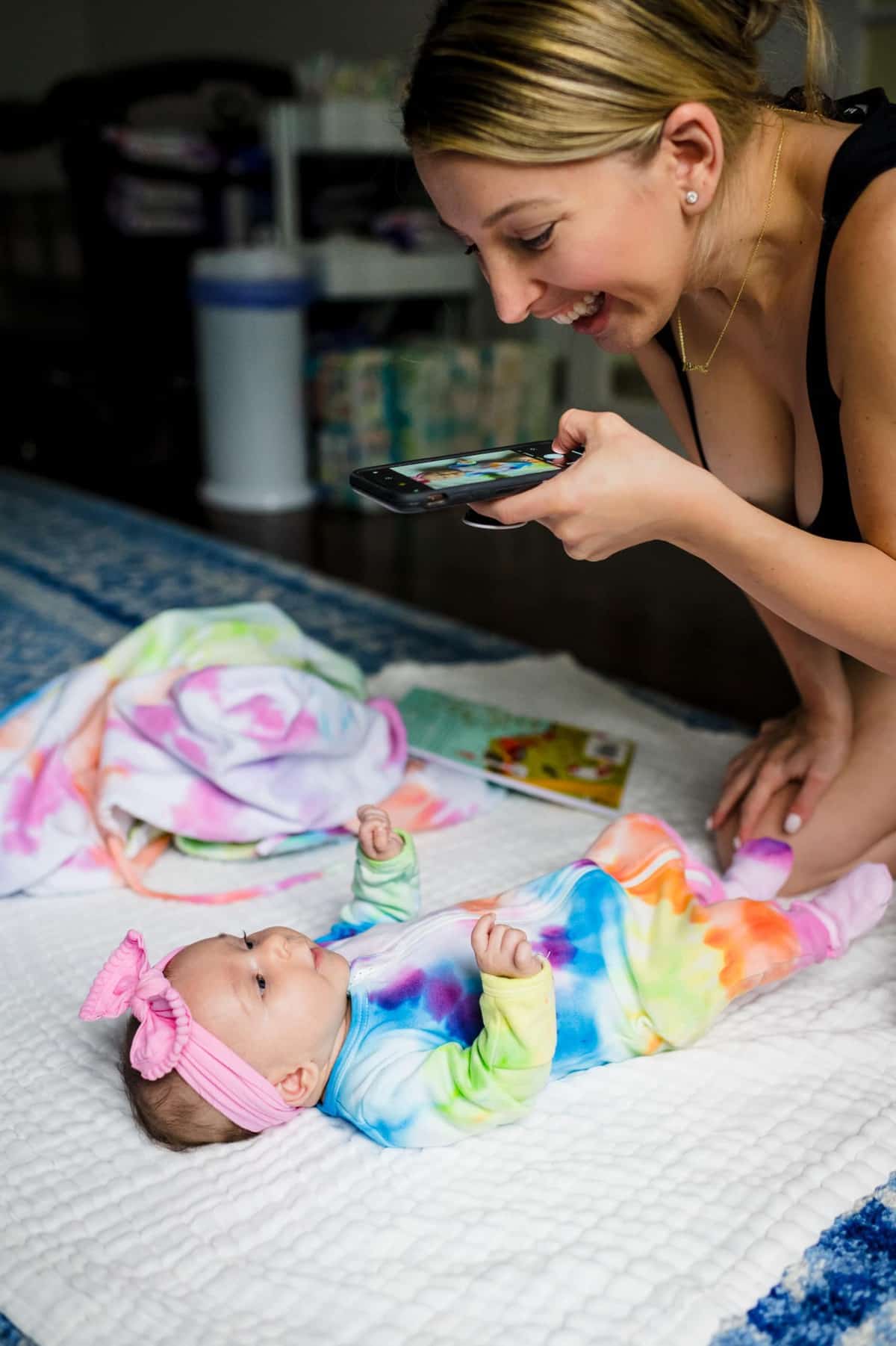 Woman taking photo of her baby on cell phone