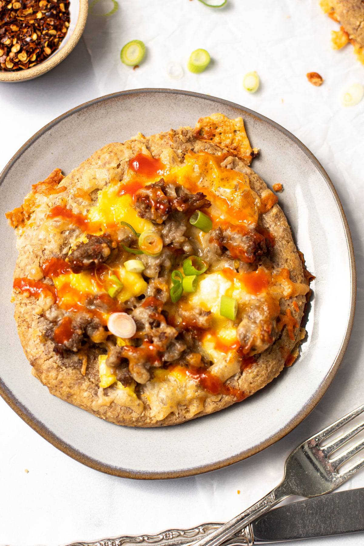 Breakfast pizza on a plate.