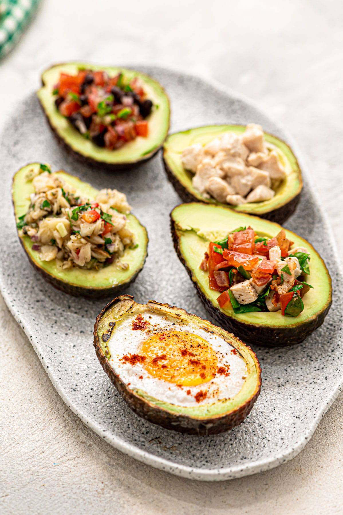 Avocado boats filled with five different options.