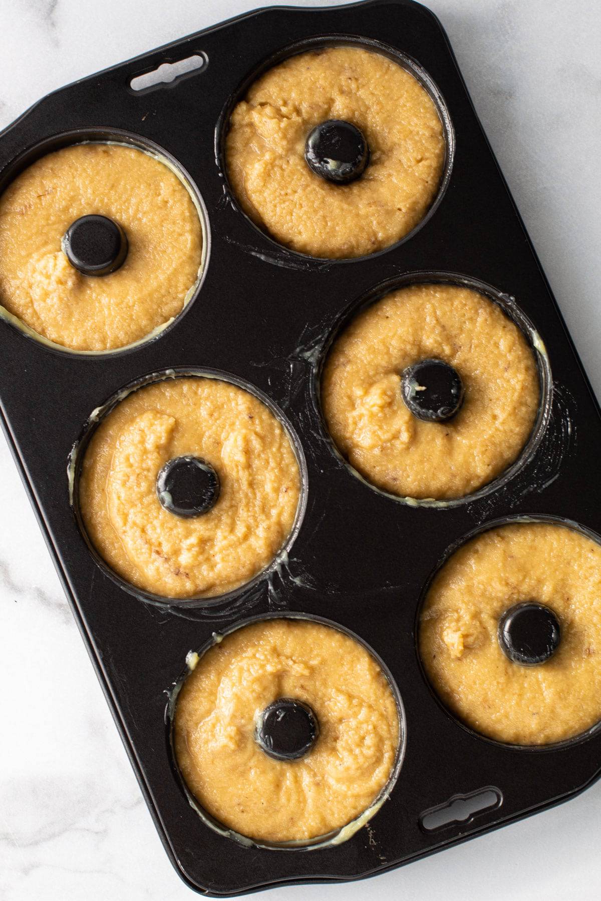 Gluten Free Banana Doughnuts in a baking tray.