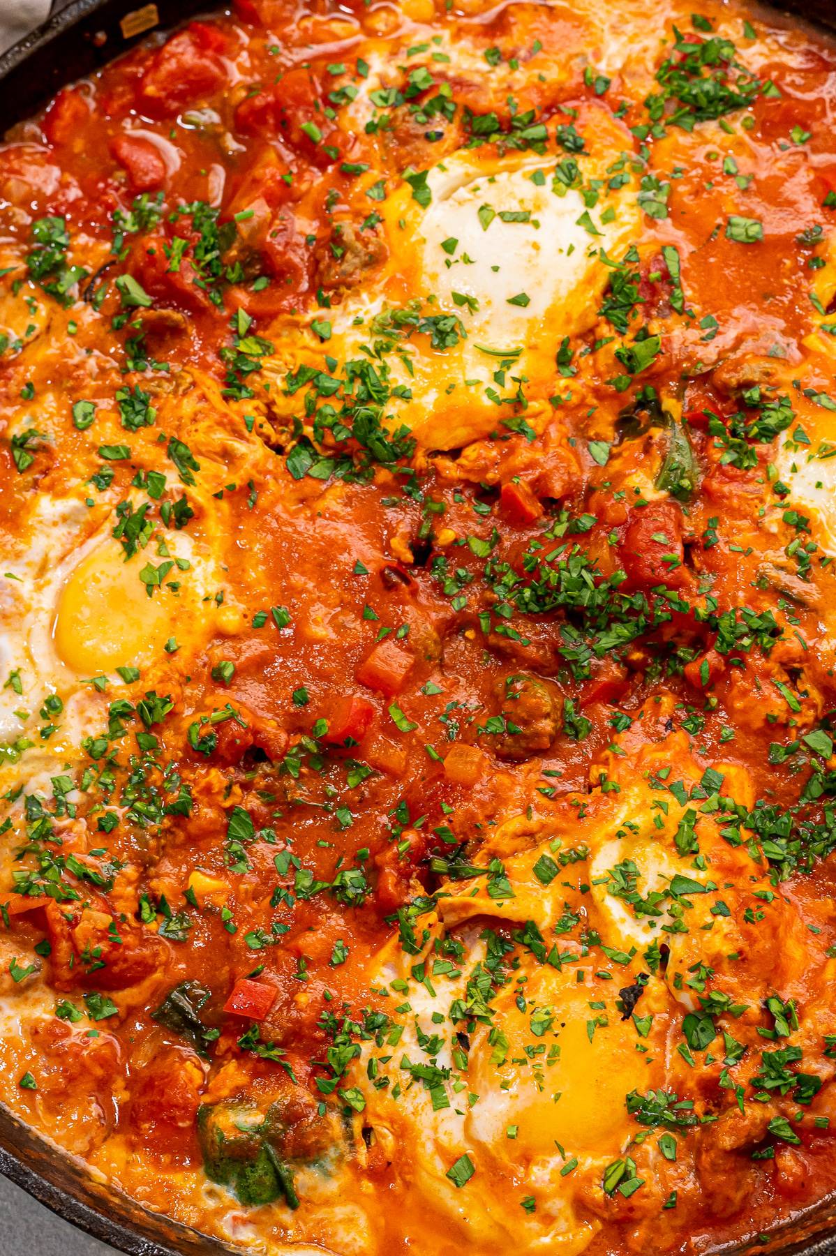 closeup of shakshuka sprinkled with fresh parsley.