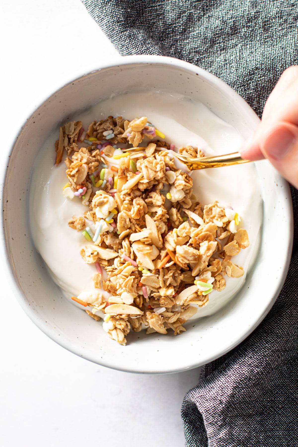 A bowl full of birthday cake granola and yogurt.