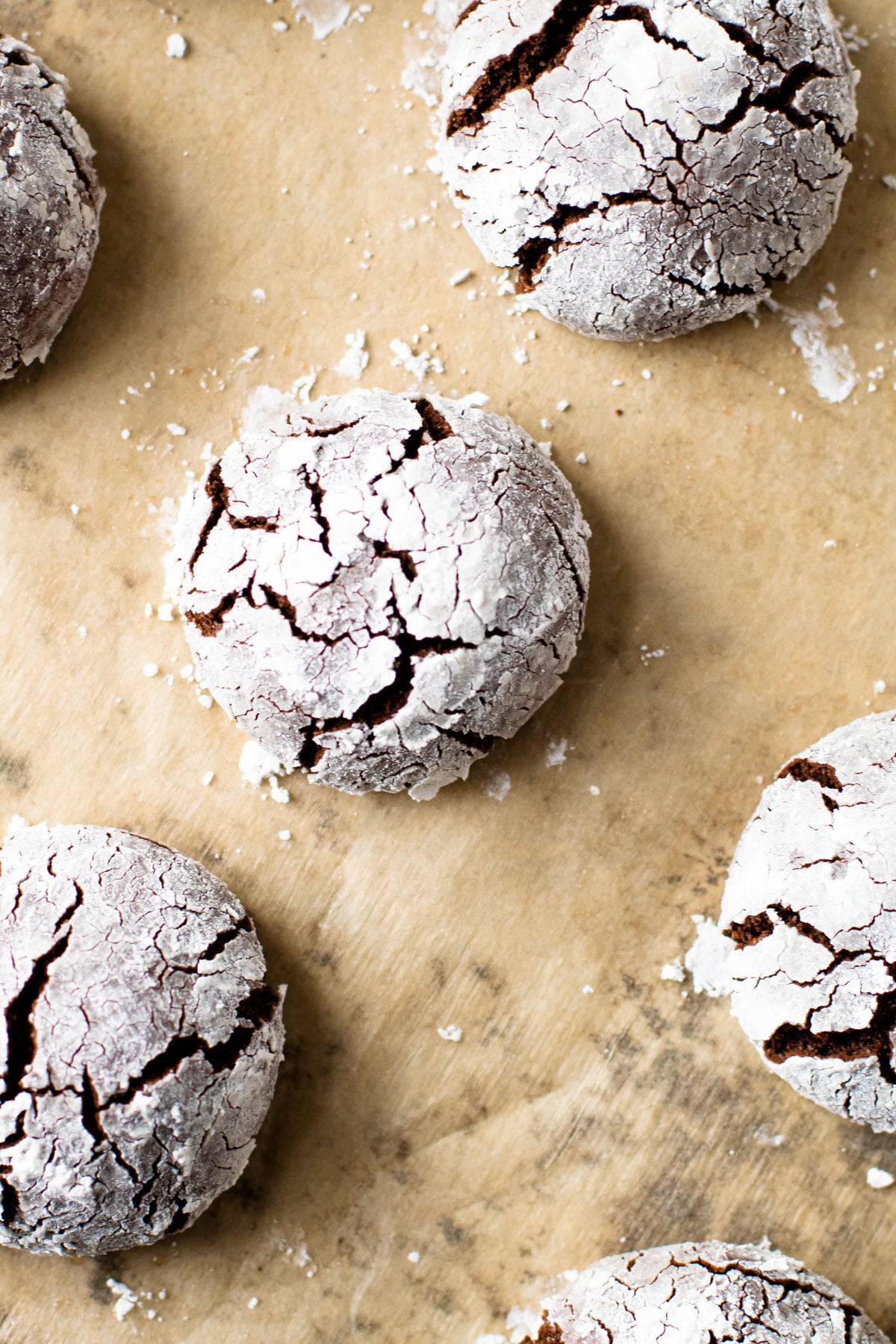 Gluten-free chocolate crinkle cookies on a baking sheet.