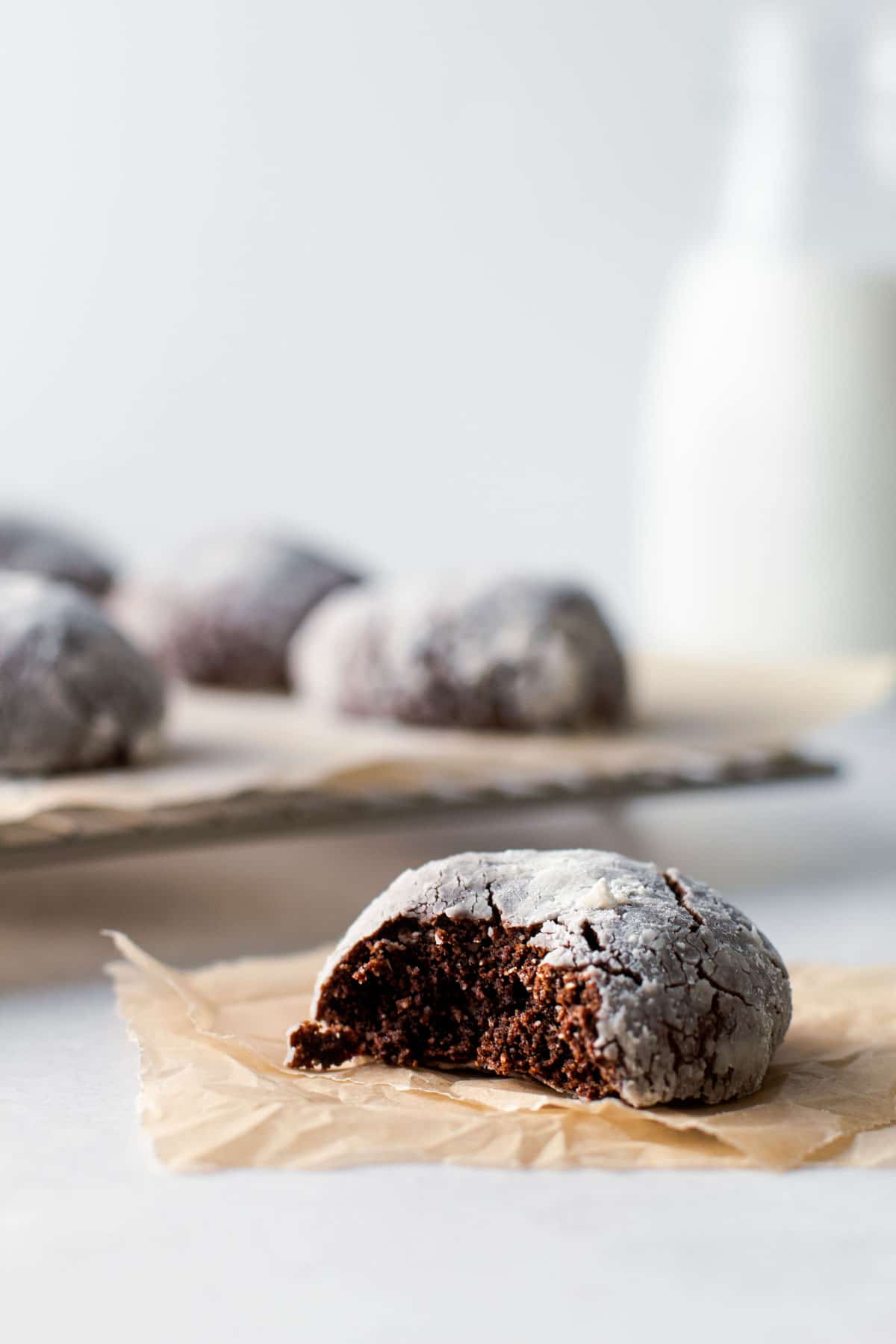Gluten free chocolate crinkle cookie with a but taken from it.
