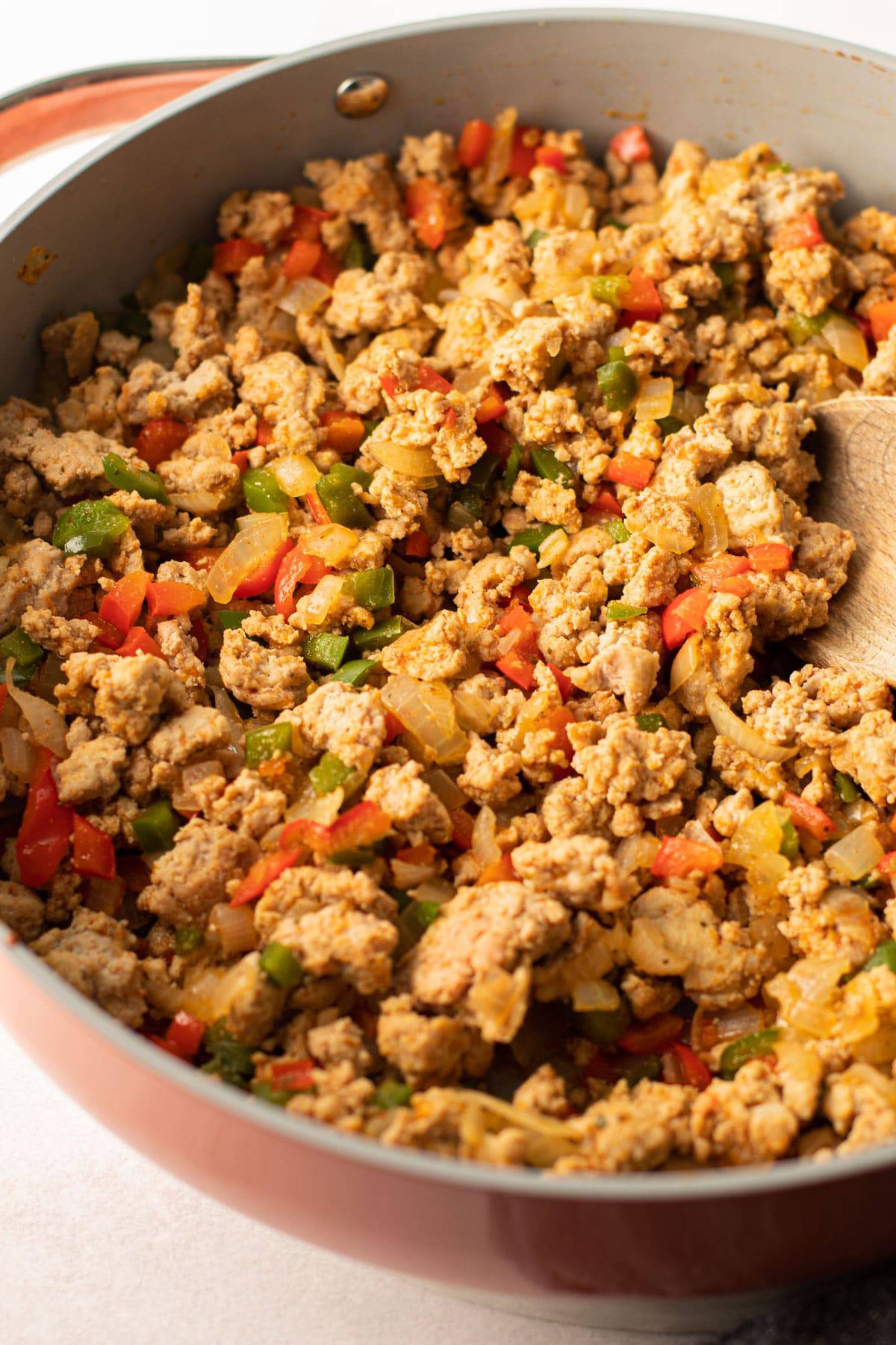 Ground turkey and veggies in a pan.