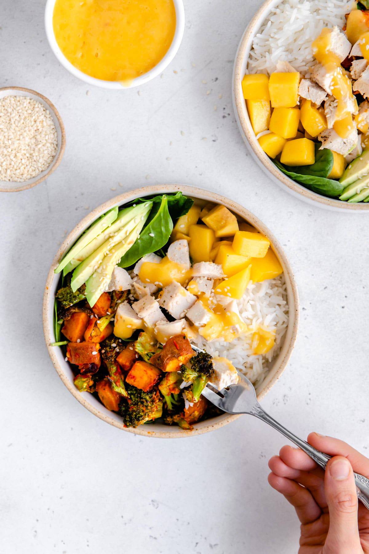 A chicken buddha bowl with mango and avocado.