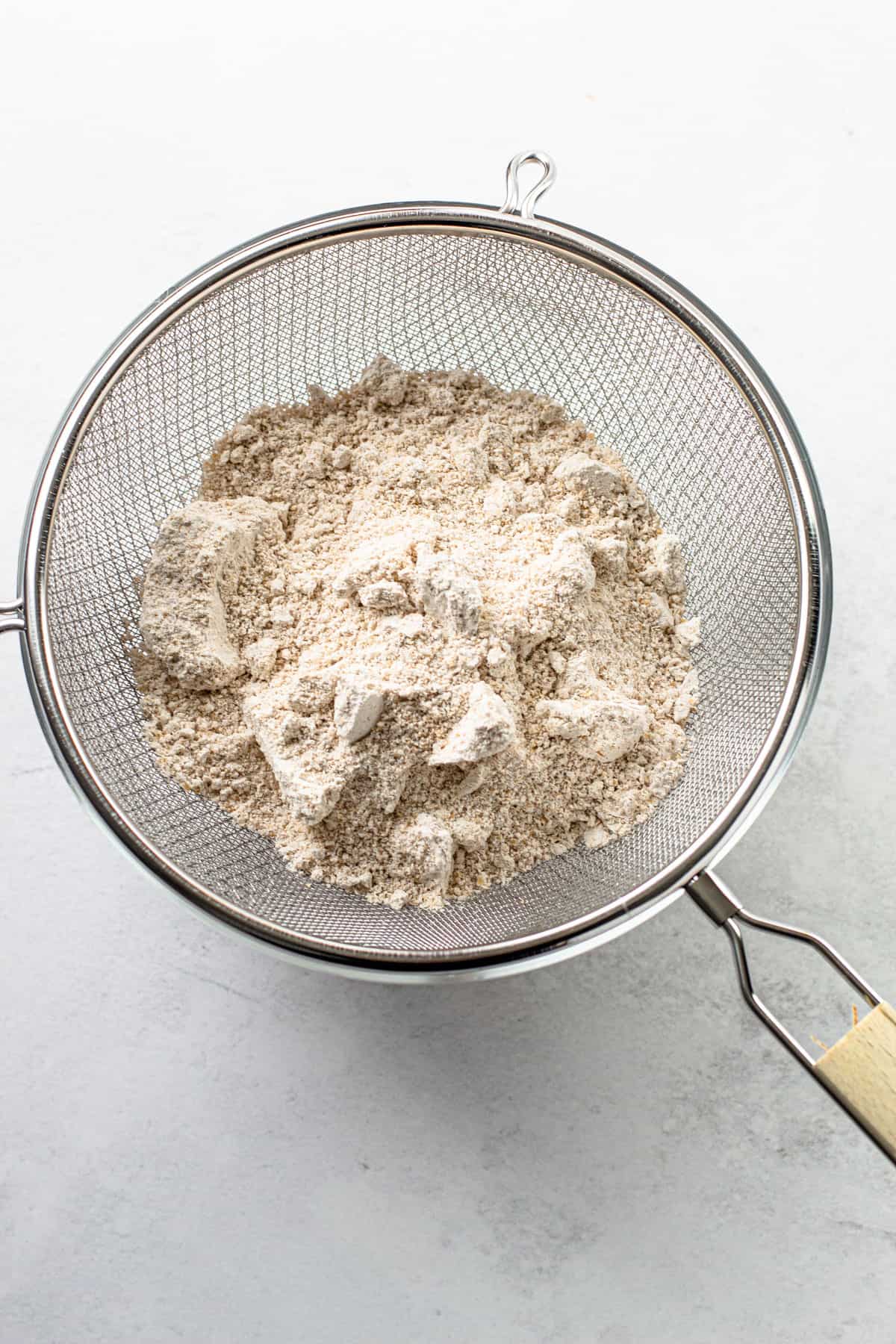 Sifting oat flour.