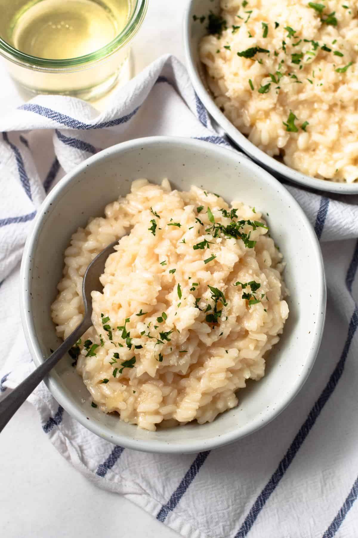 Two bowls of creamy risotto.