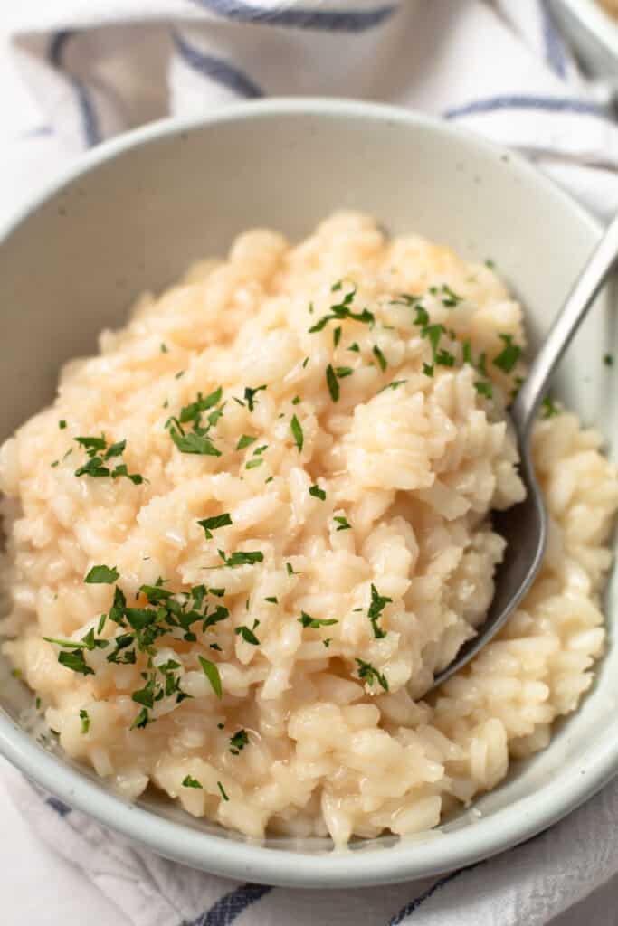 Classic risotto in bowl with parsley on top.