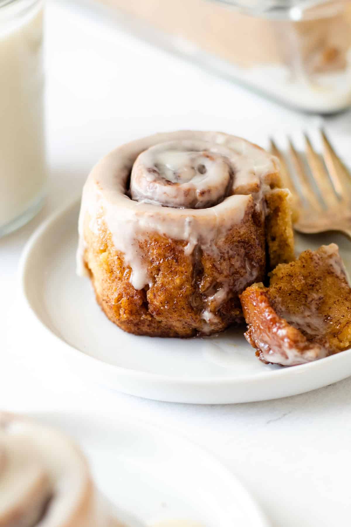 A gluten-free cinnamon roll on a plate.