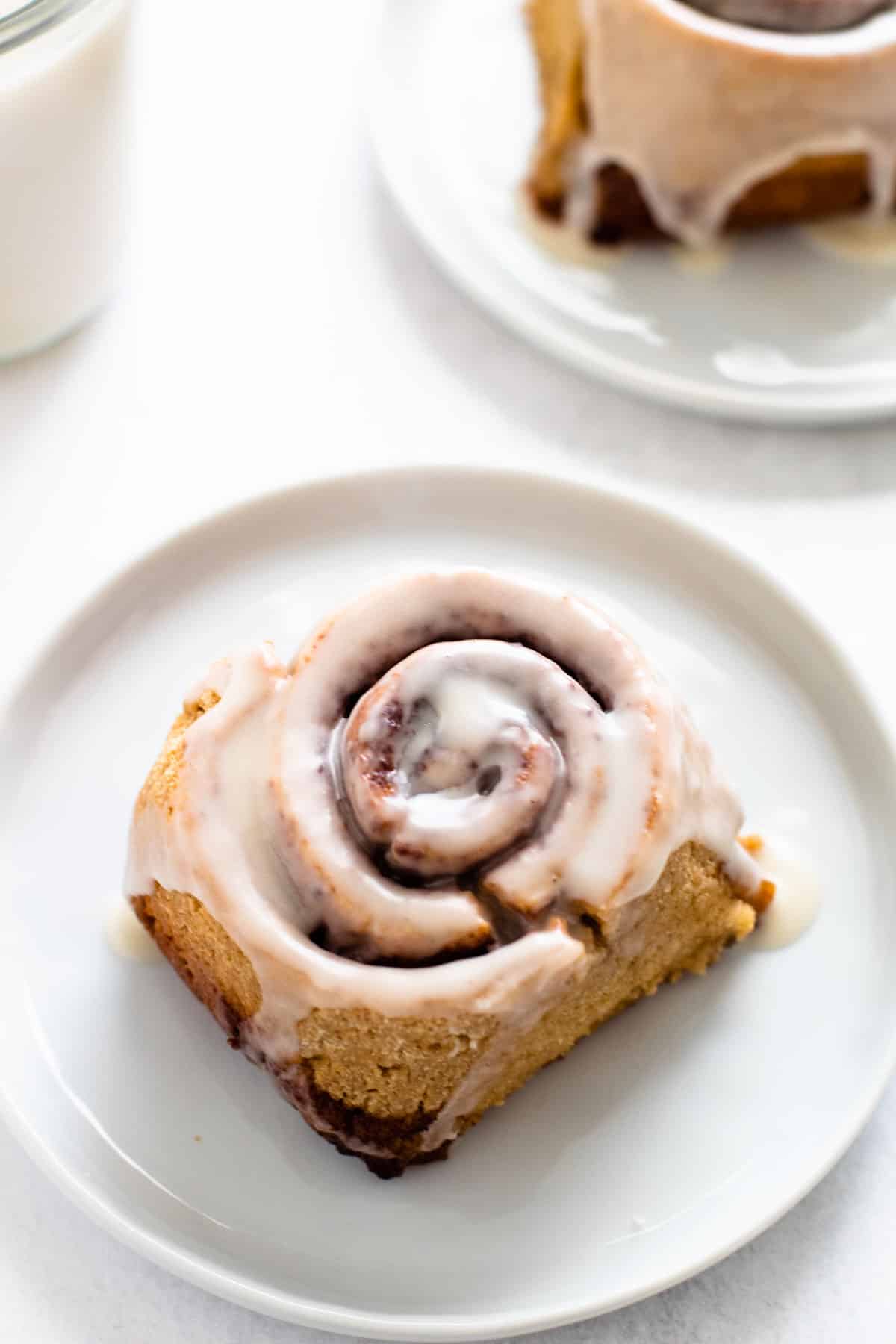 A gluten-free cinnamon roll on a plate.