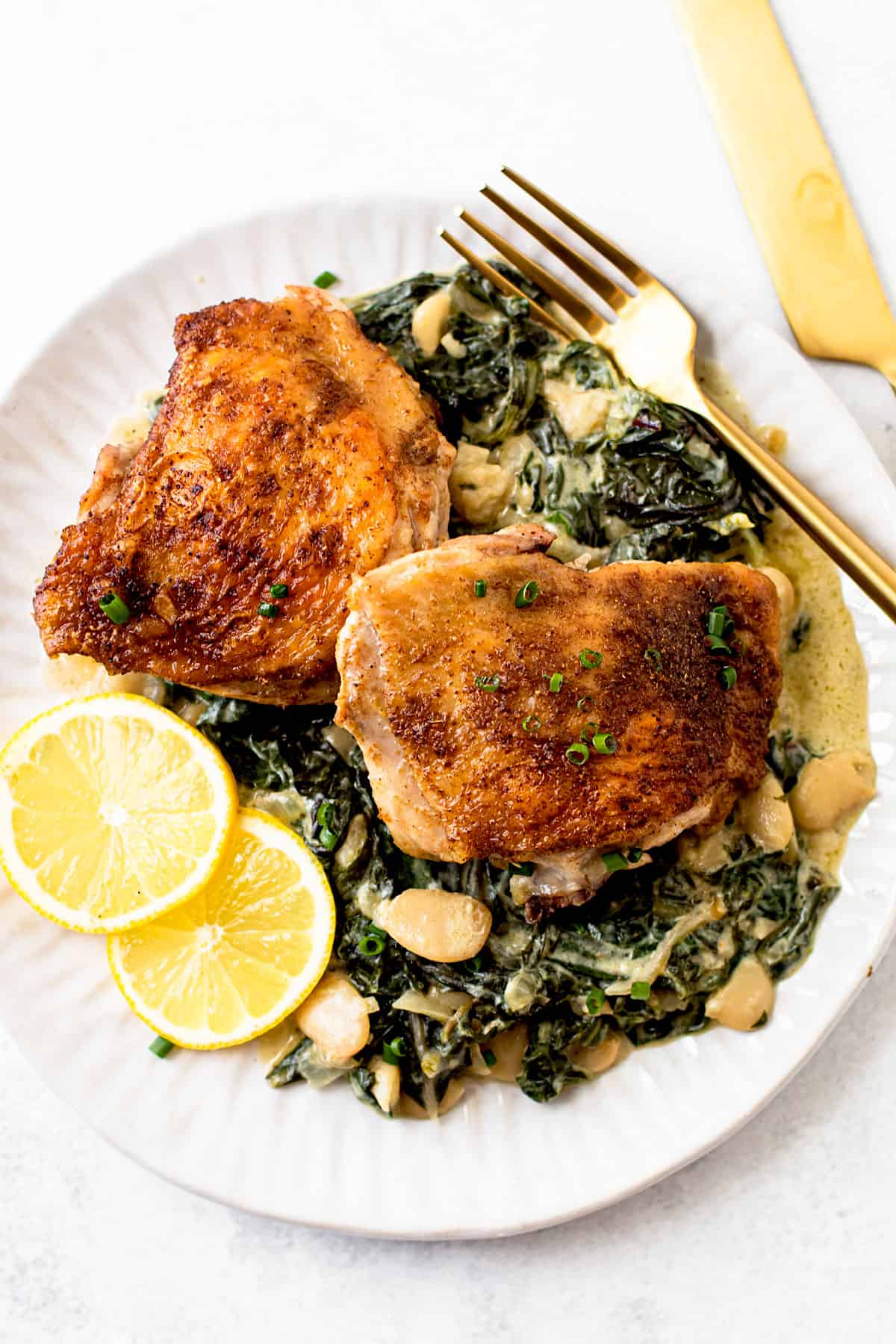 https://lexiscleankitchen.com/wp-content/uploads/2021/05/Chicken-Thighs-with-Creamy-Lemon-Greens-4.jpg