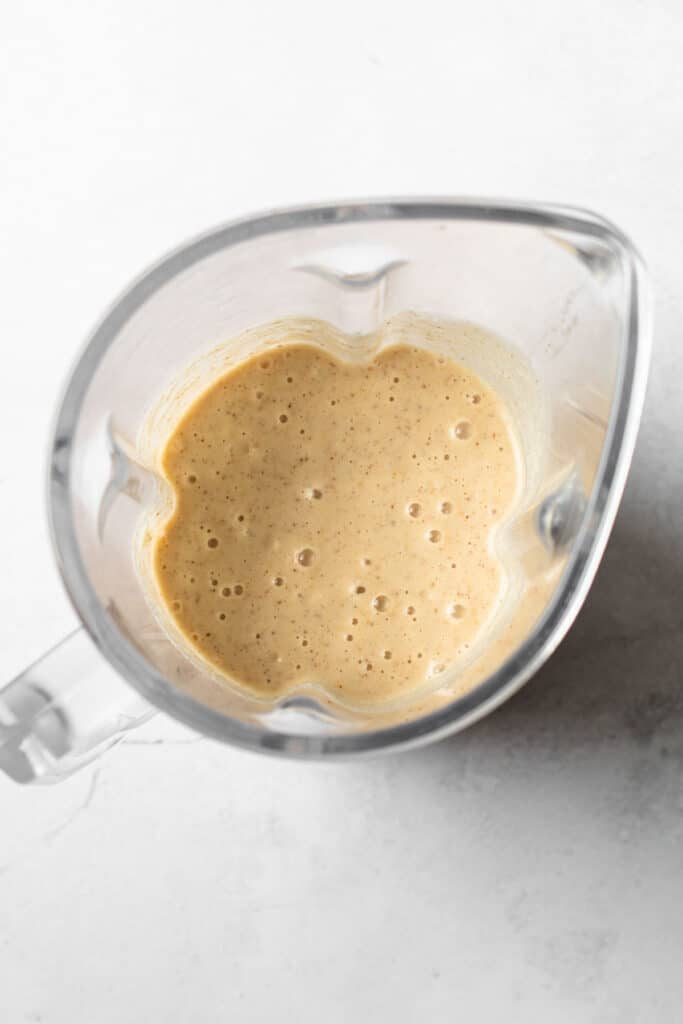 Peanut Butter and banana smoothie blended up in a blender.