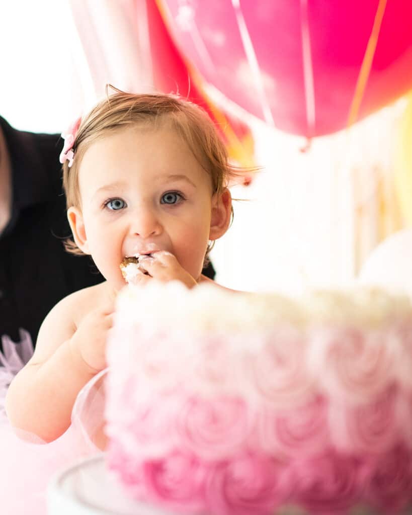 A baby eating a healthy smash cake.