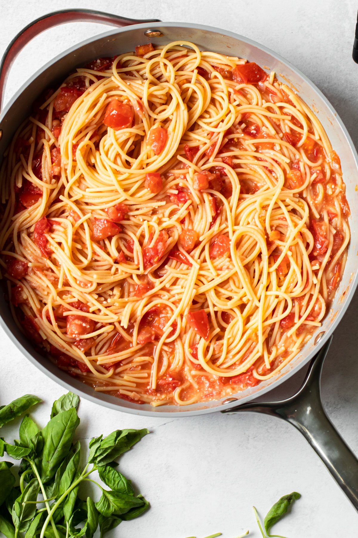 Fresh tomato pasta in a skillet.