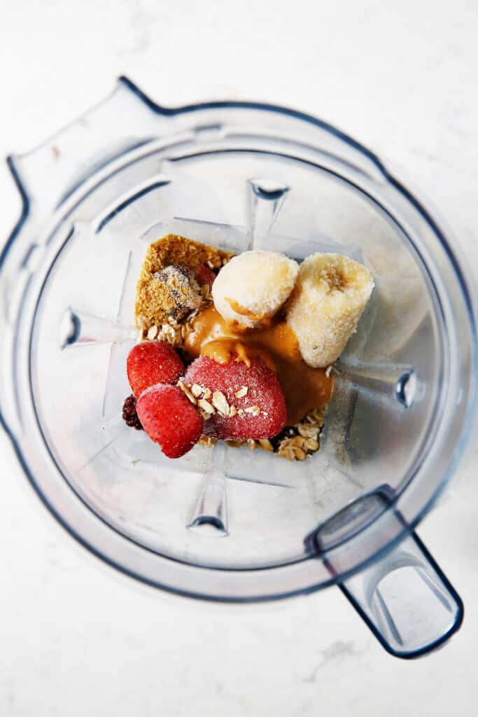 PBJ smoothie ingredients in a blender before being blended.