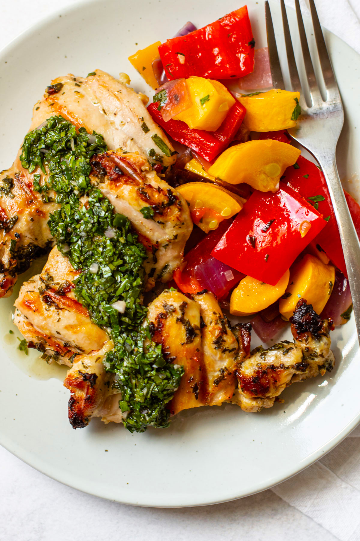 Chimichurri chicken on a plate with veggies.