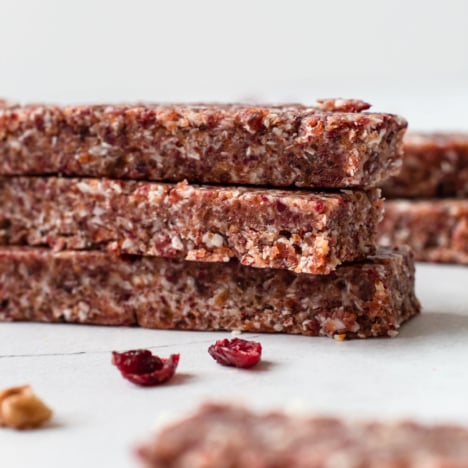 Cranberry coconut protein bars stacked up.