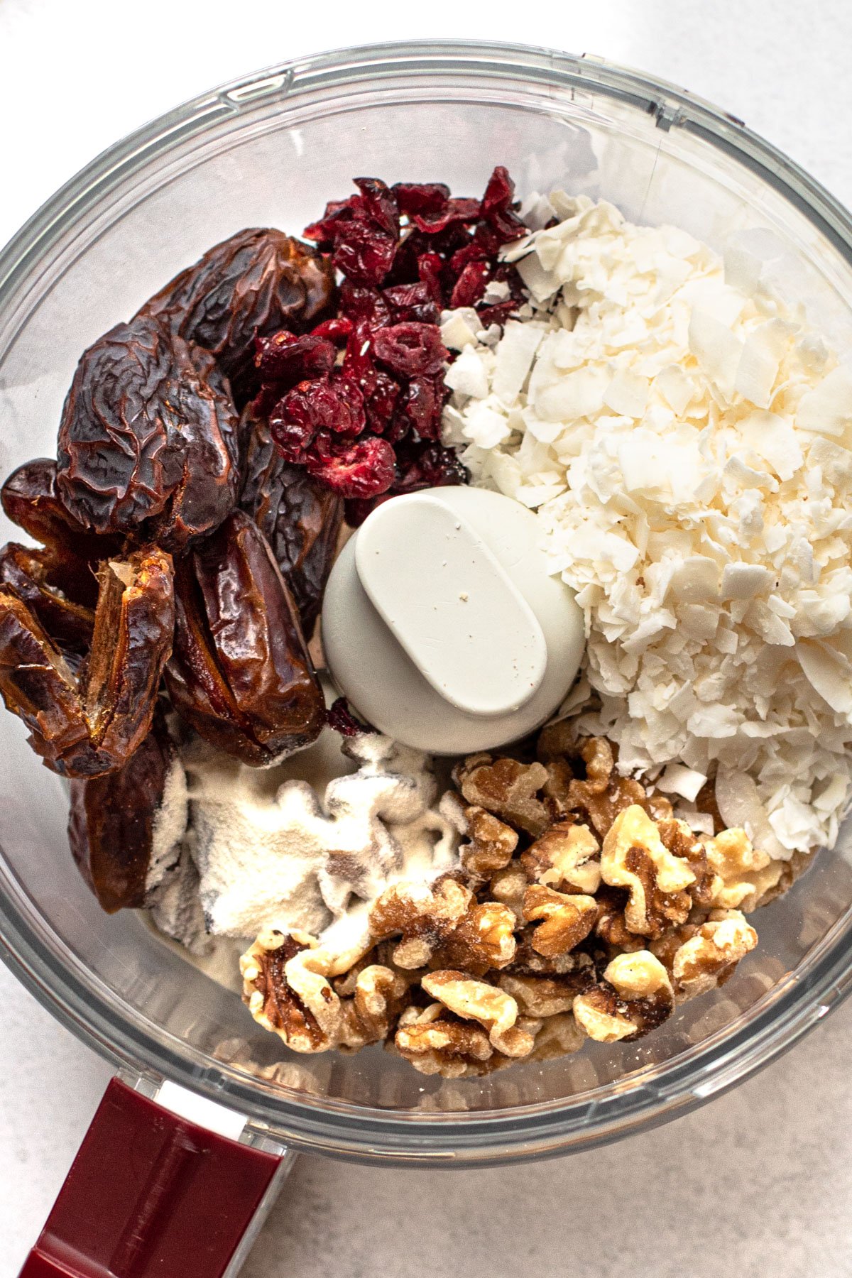 Ingredients in a food processor for cranberry coconut bars.