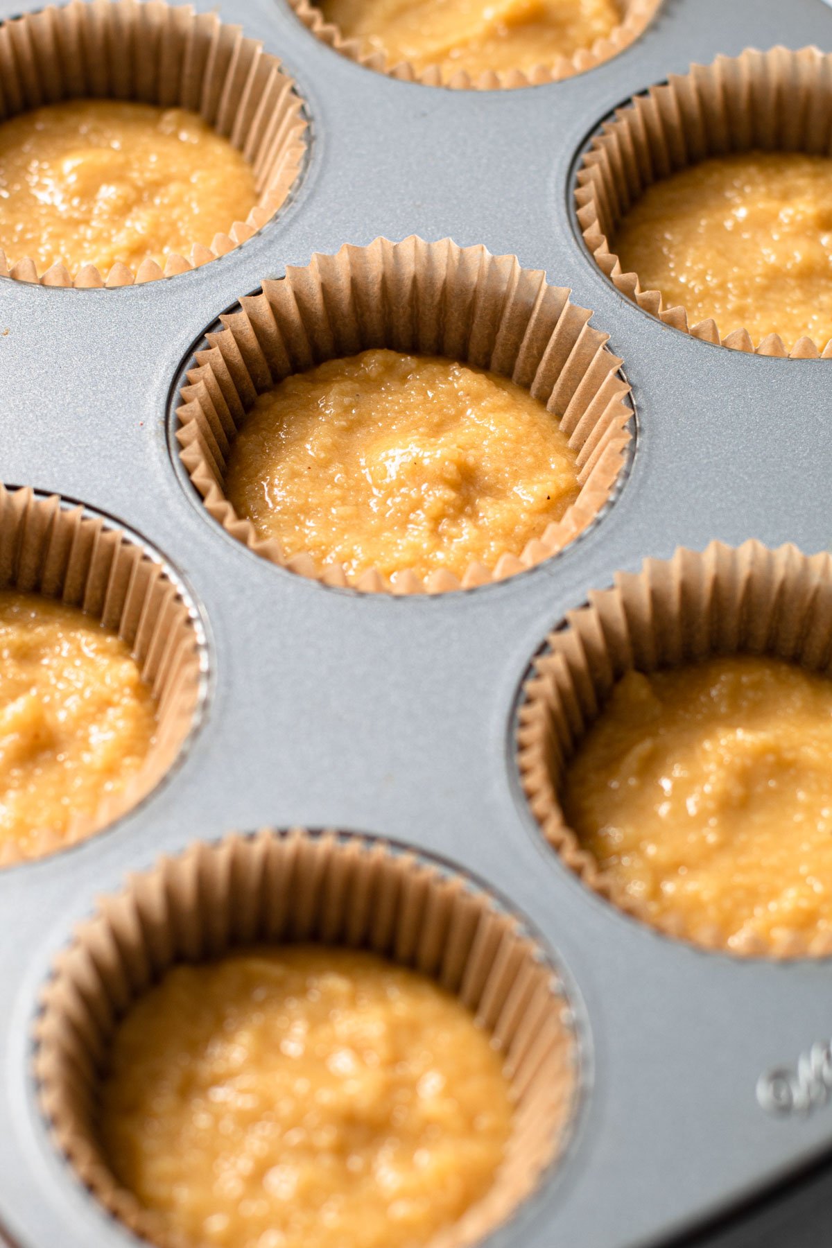 Gluten free vanilla cupcake batter in muffin cups.
