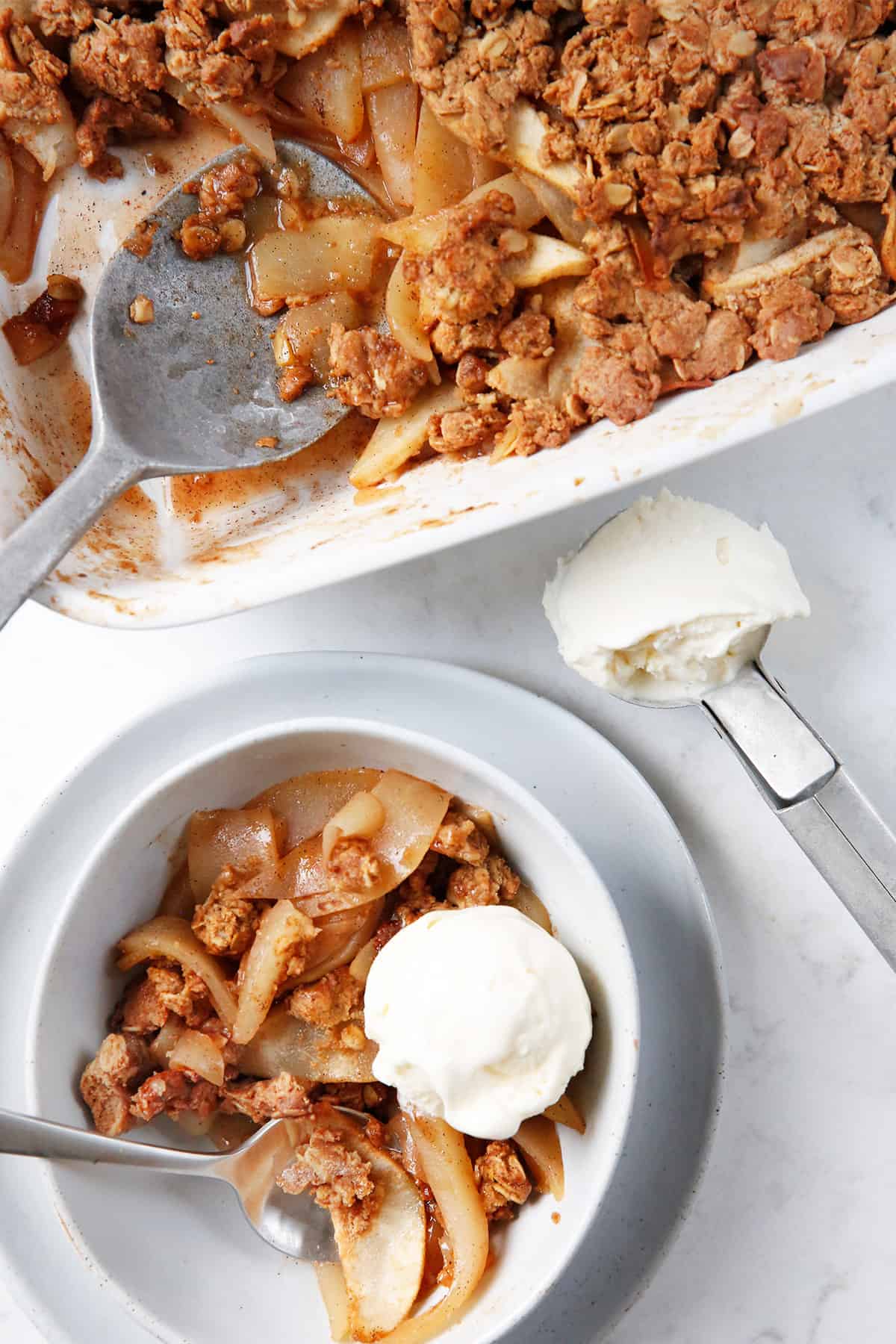pear crisp recipe ready to eat with a scoop of ice cream