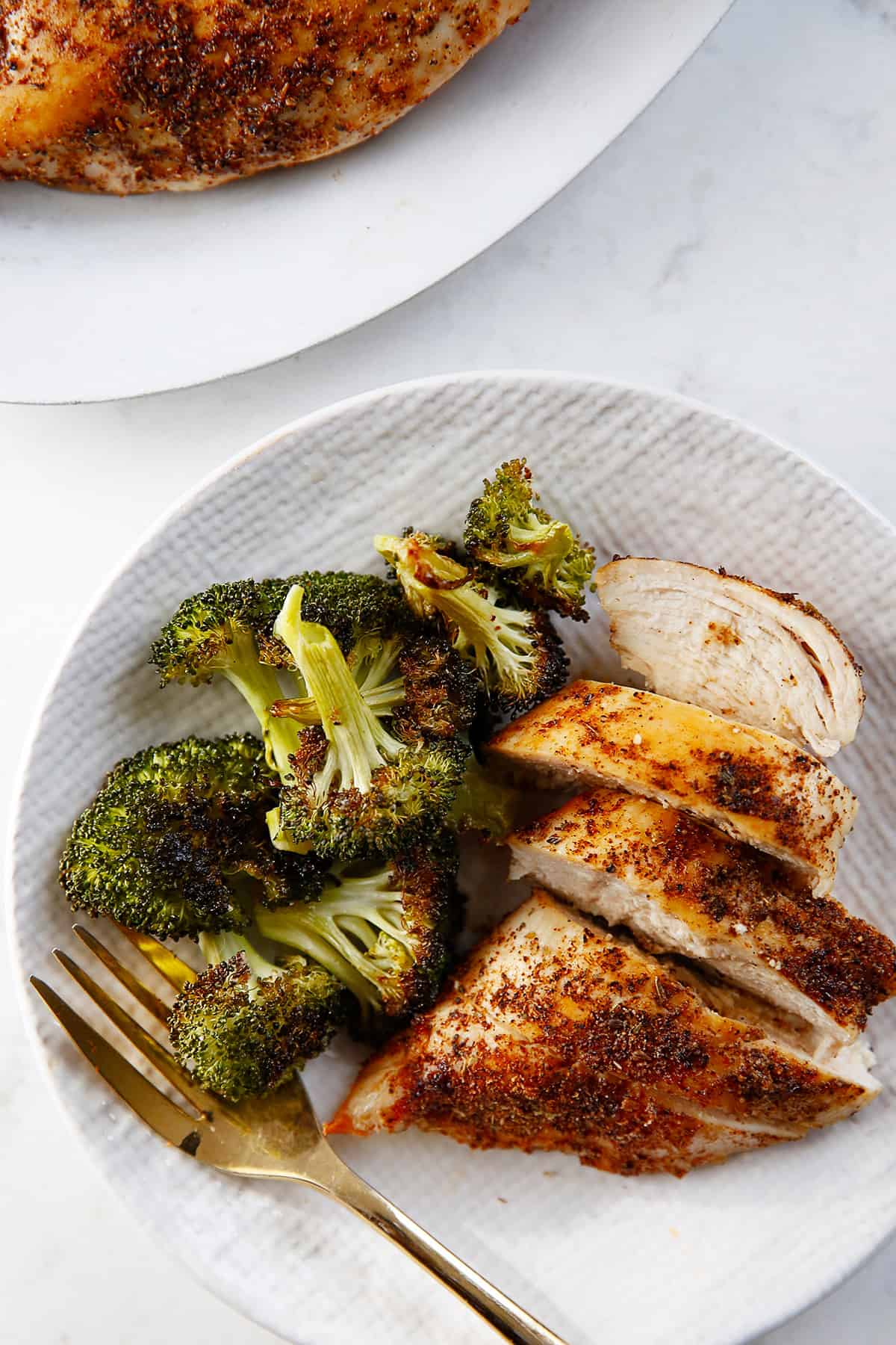 chicken breast air fryer on a plate with broccoli