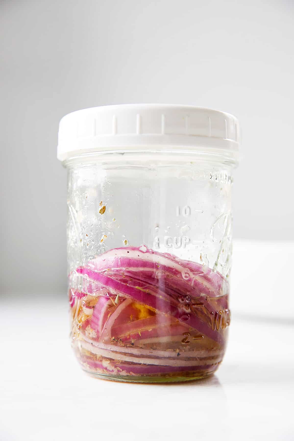Red onions in dressing for Spring Mix Salad