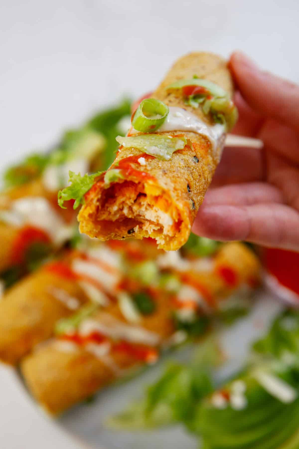 A bite of the inside of a Buffalo Chicken Taquitos