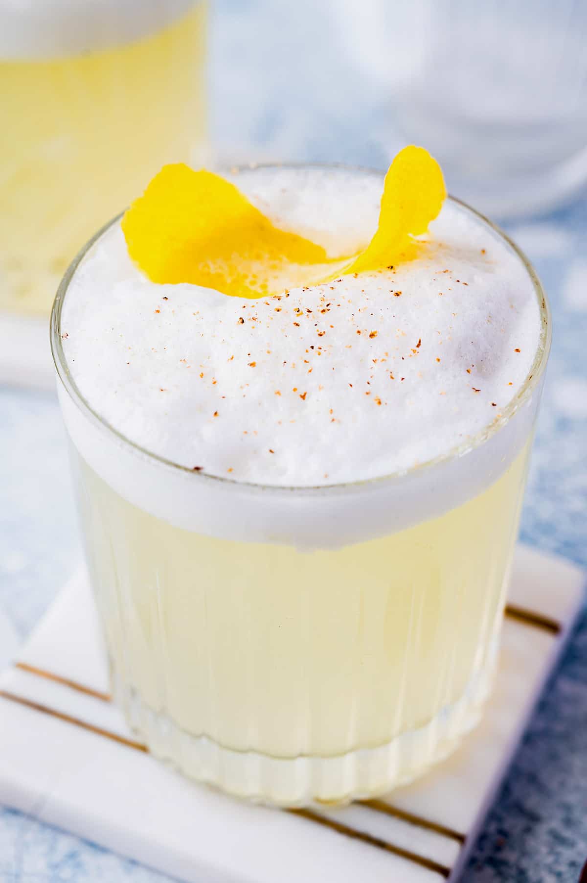 Gin Fizz Cocktail with a lemon twist and nutmeg garnish