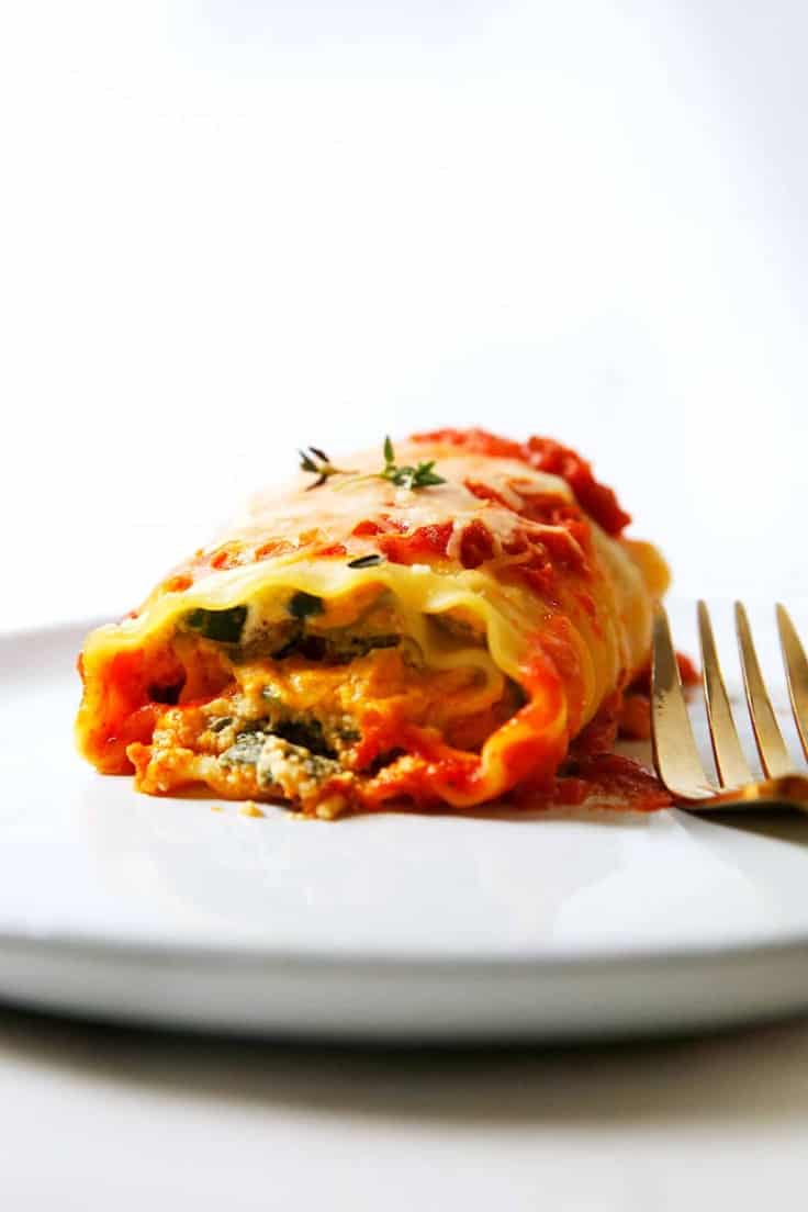 A plate of a pumpkin lasagna roll up ready to eat.