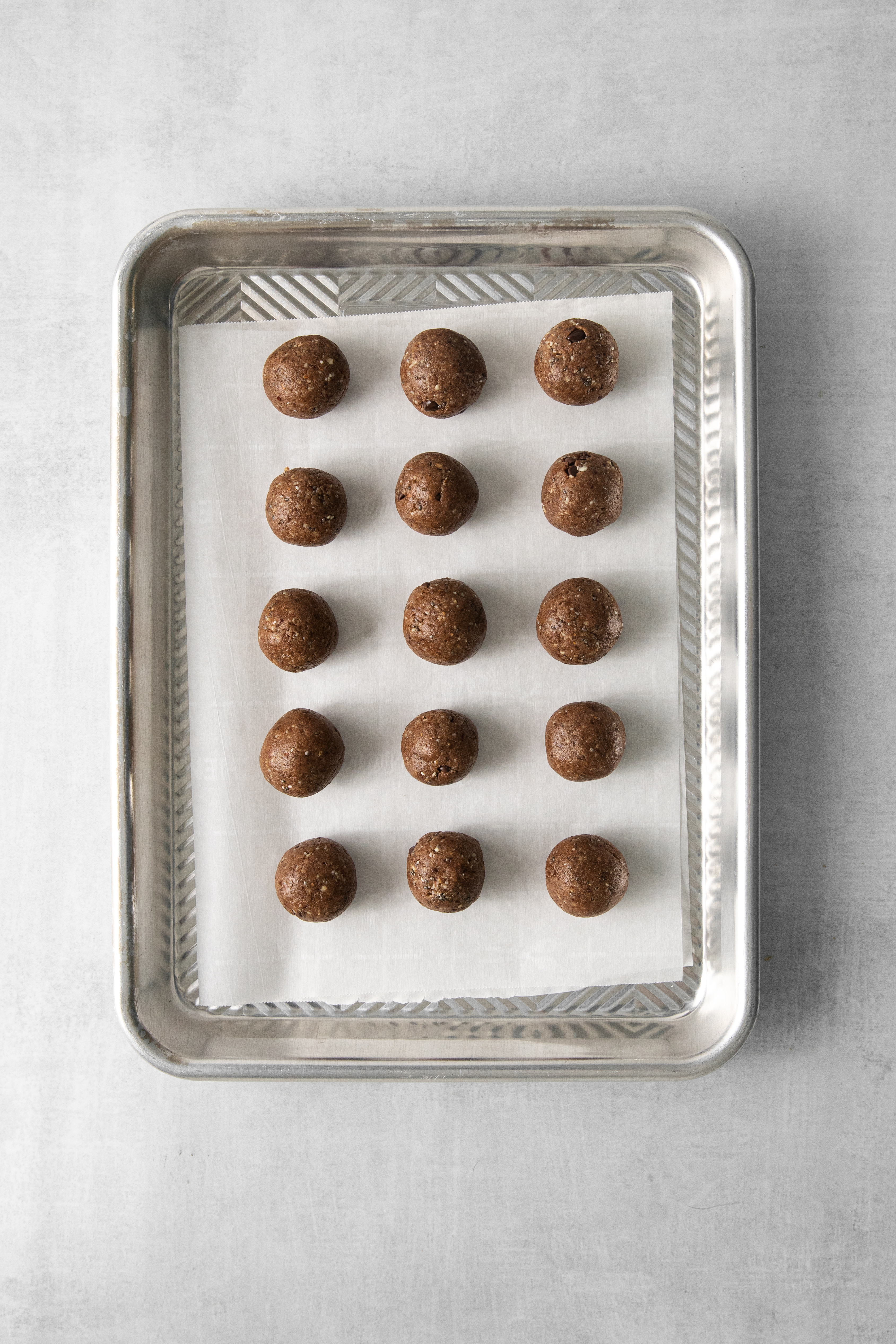 rolled energy bites on a baking sheet.