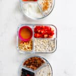 overhead of three meal prep containers with different variations of overnight oats.