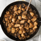 overhead of a skillet pan filled with cubed chicken.
