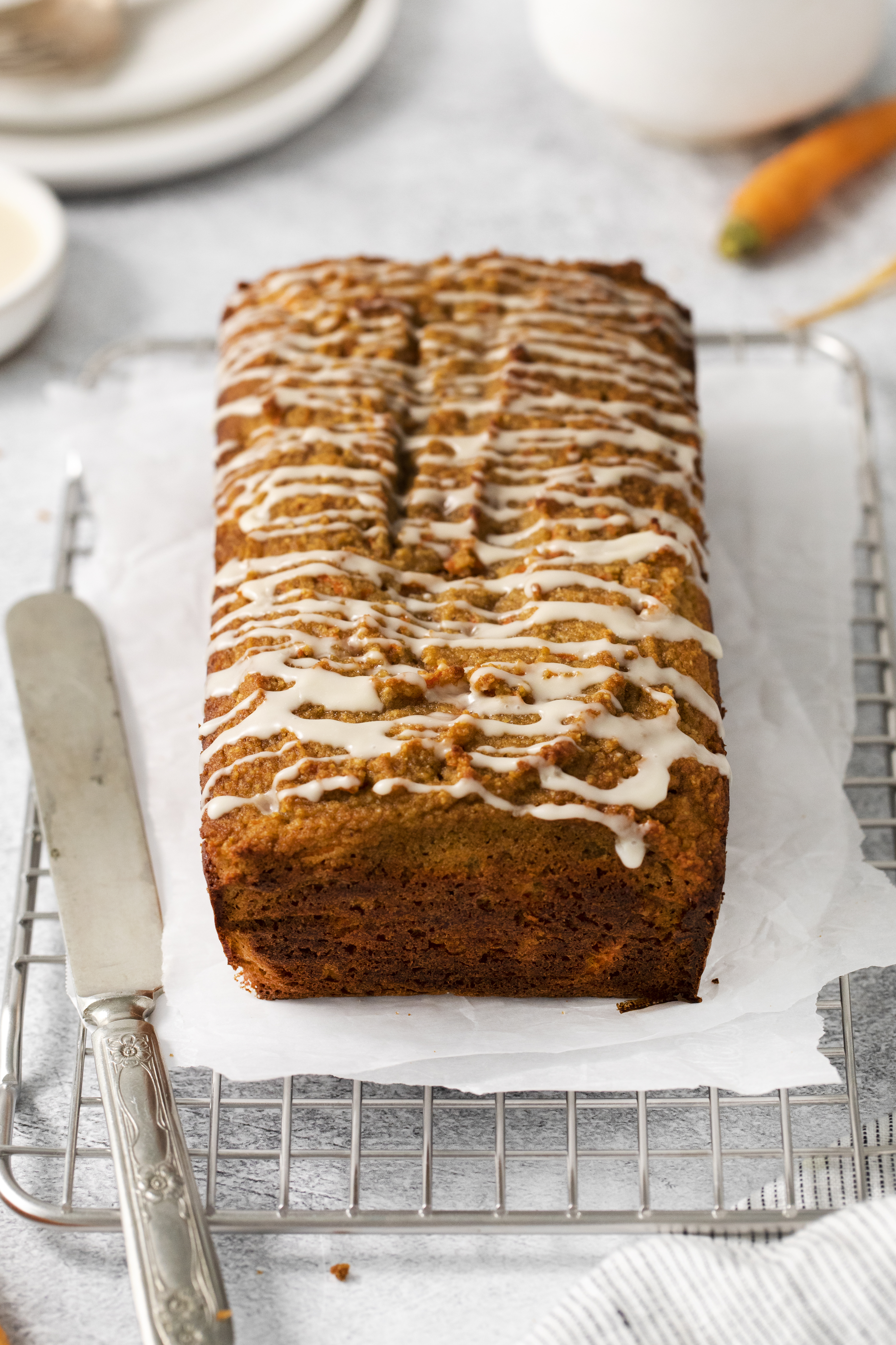 a whole loaf of carrot bread on a cooling rack.
