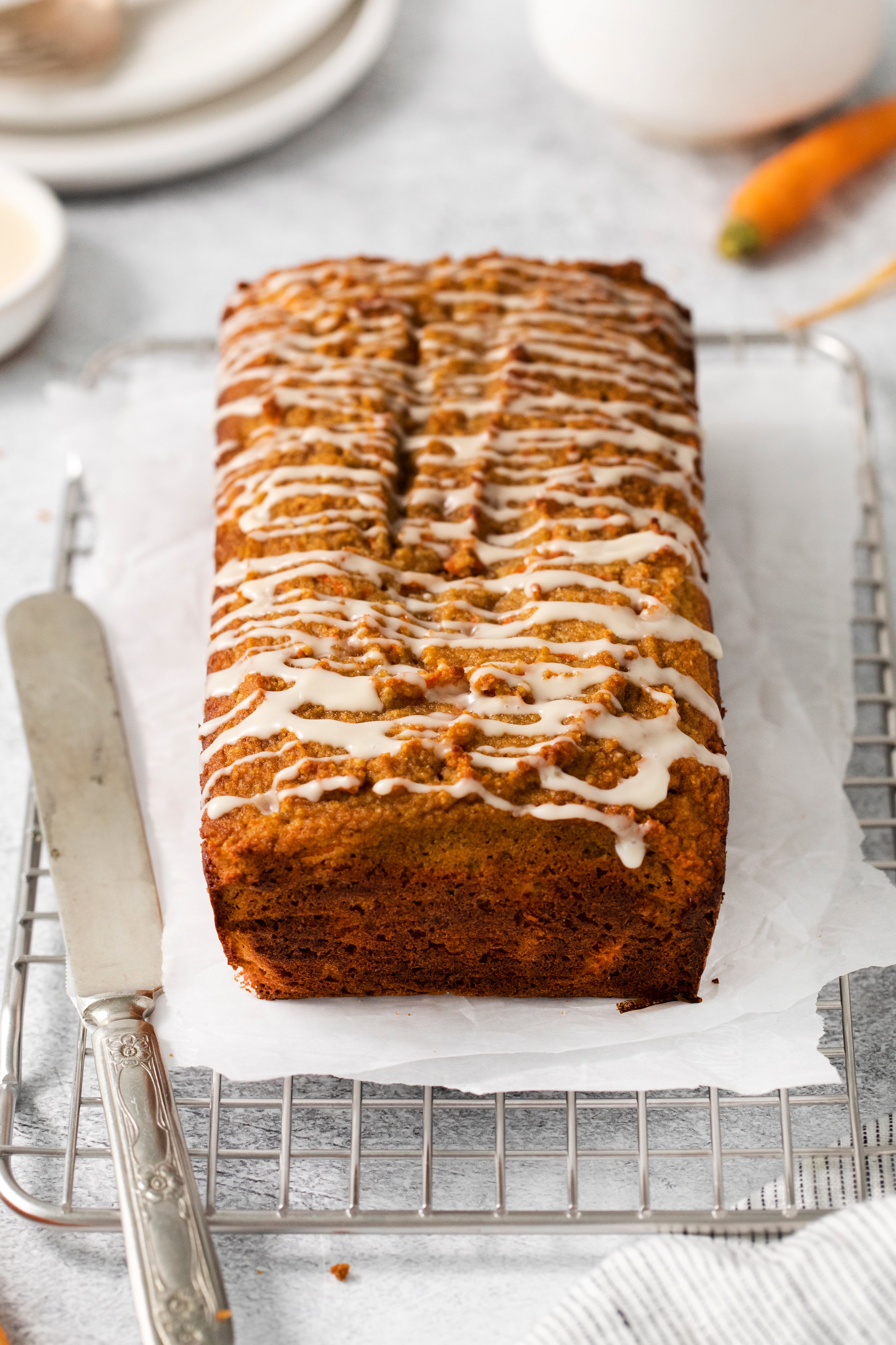 a whole loaf of carrot bread on a cooling rack.