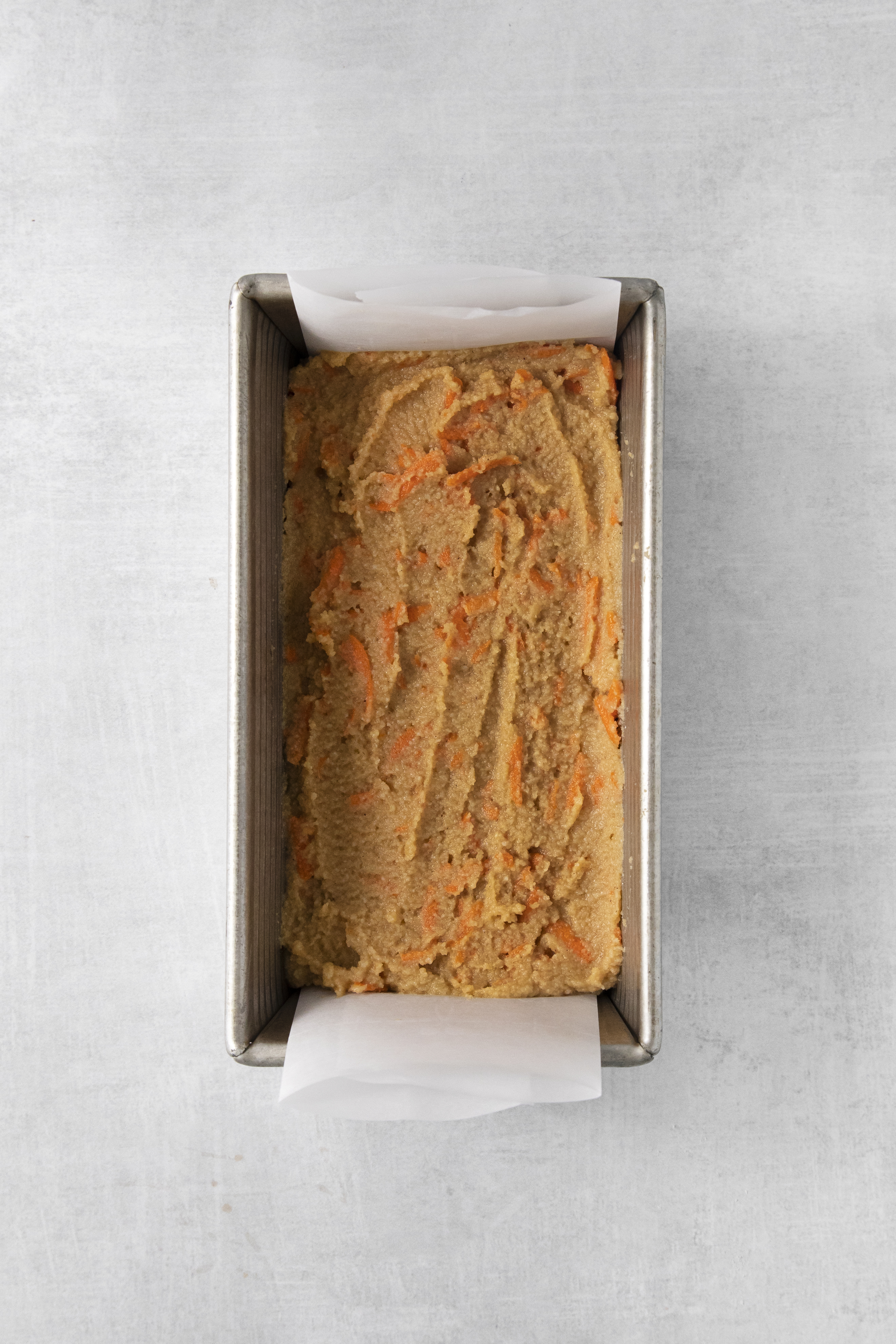 carrot cake batter in a loaf pan.