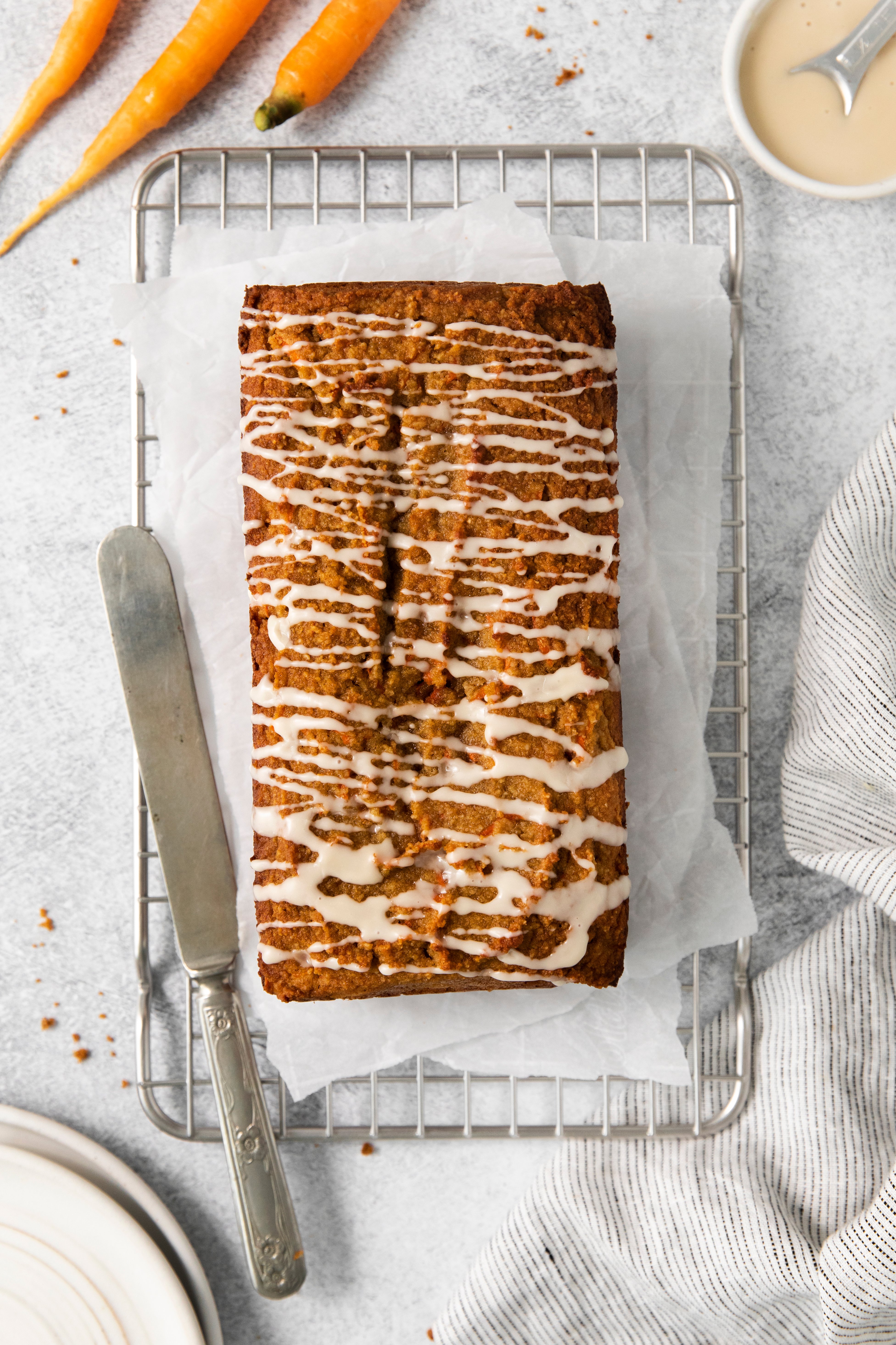overhead of a carrot cake loaf drizzled with maple glaze.