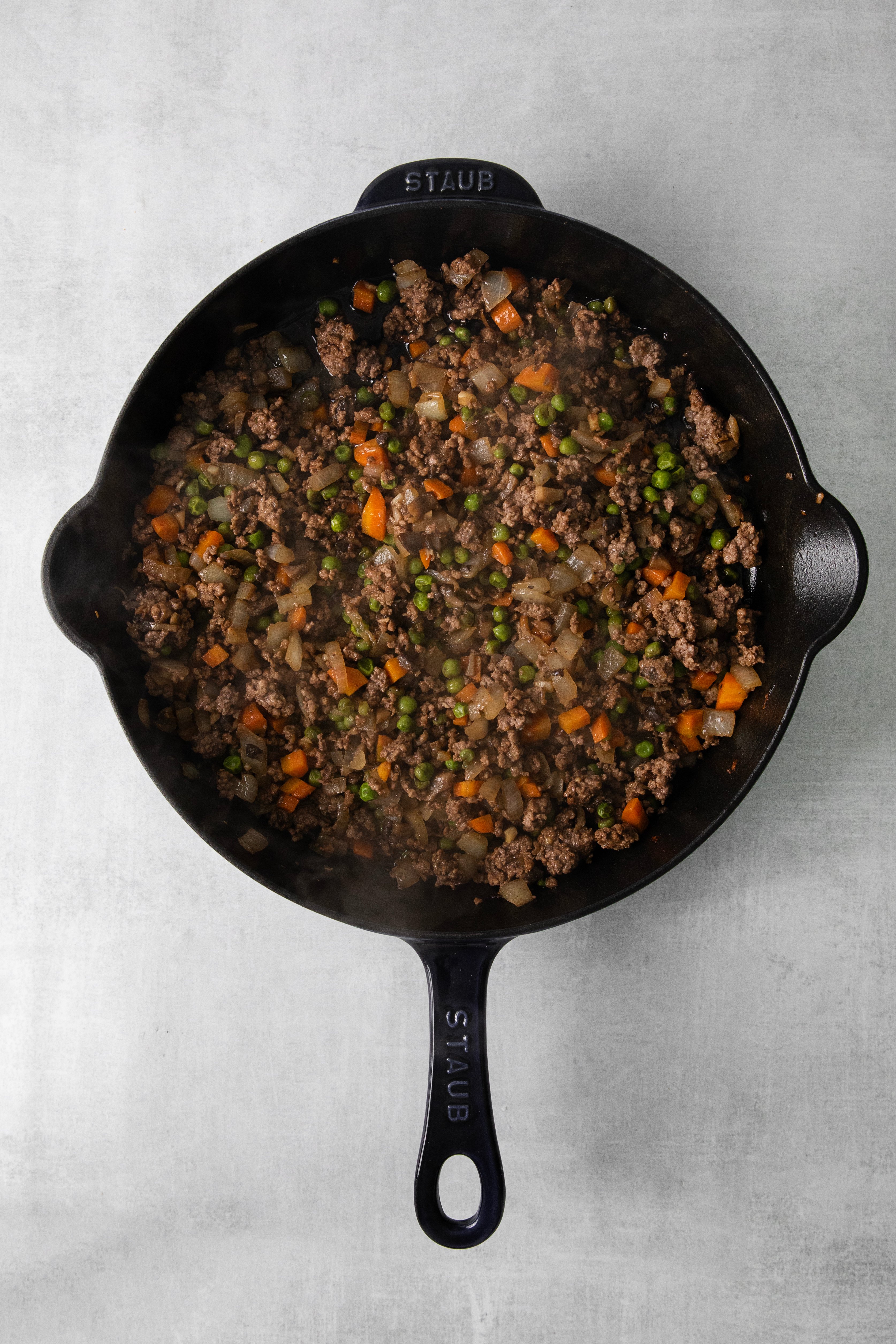 Minced meat and vegetables in a pan.