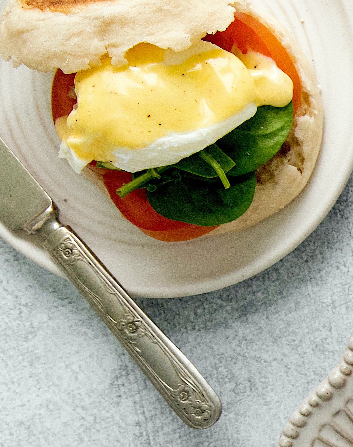 overhead of hollandaise sauce on a eggs benedict.