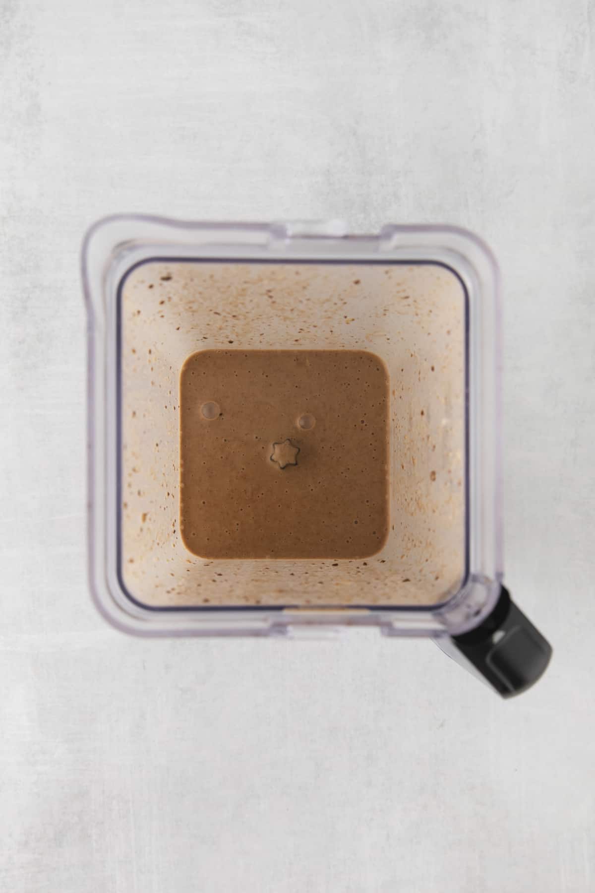 Overhead of a chocolate smoothie in a blender.