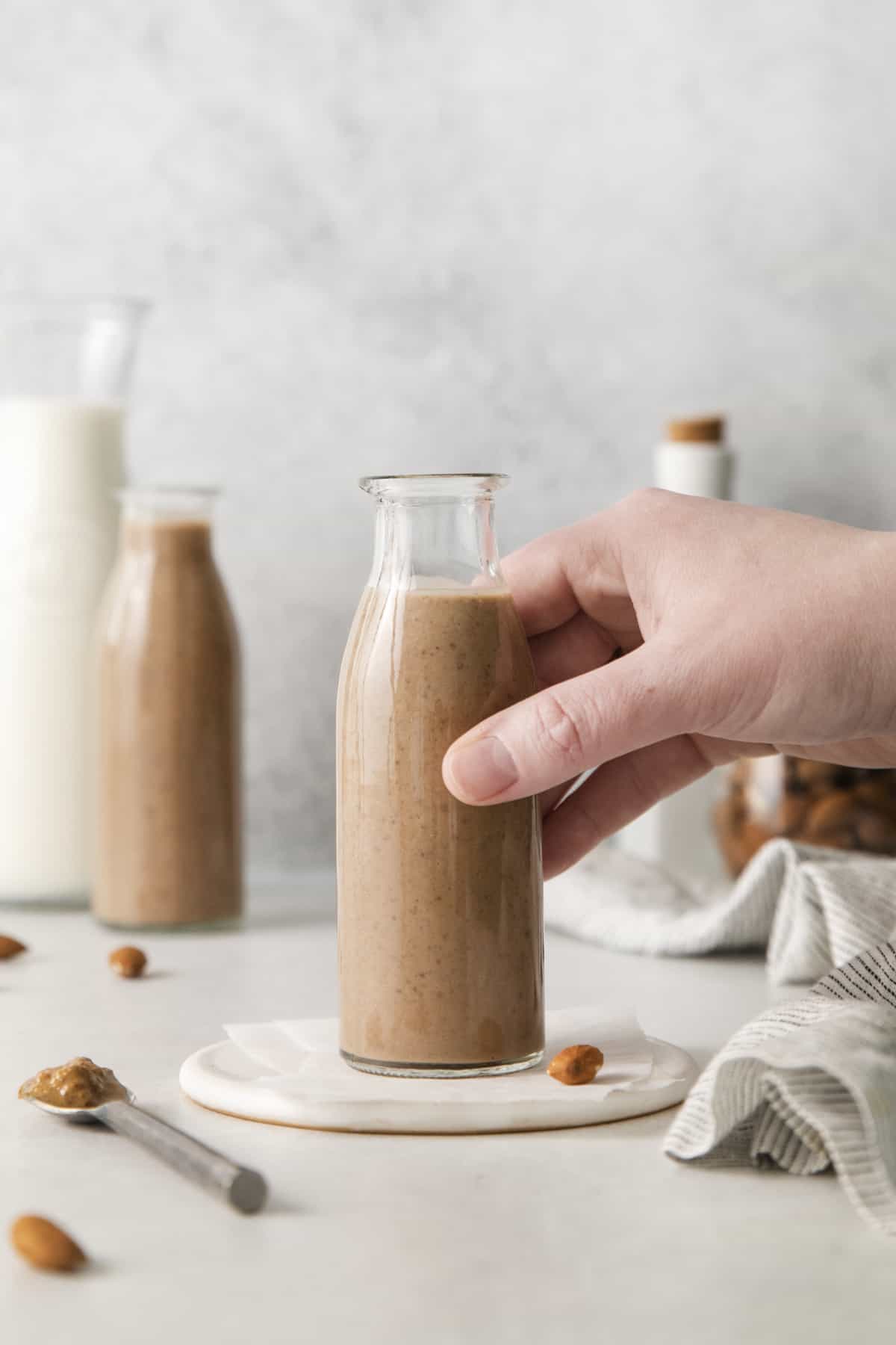 A glass with a smoothie is picked up.