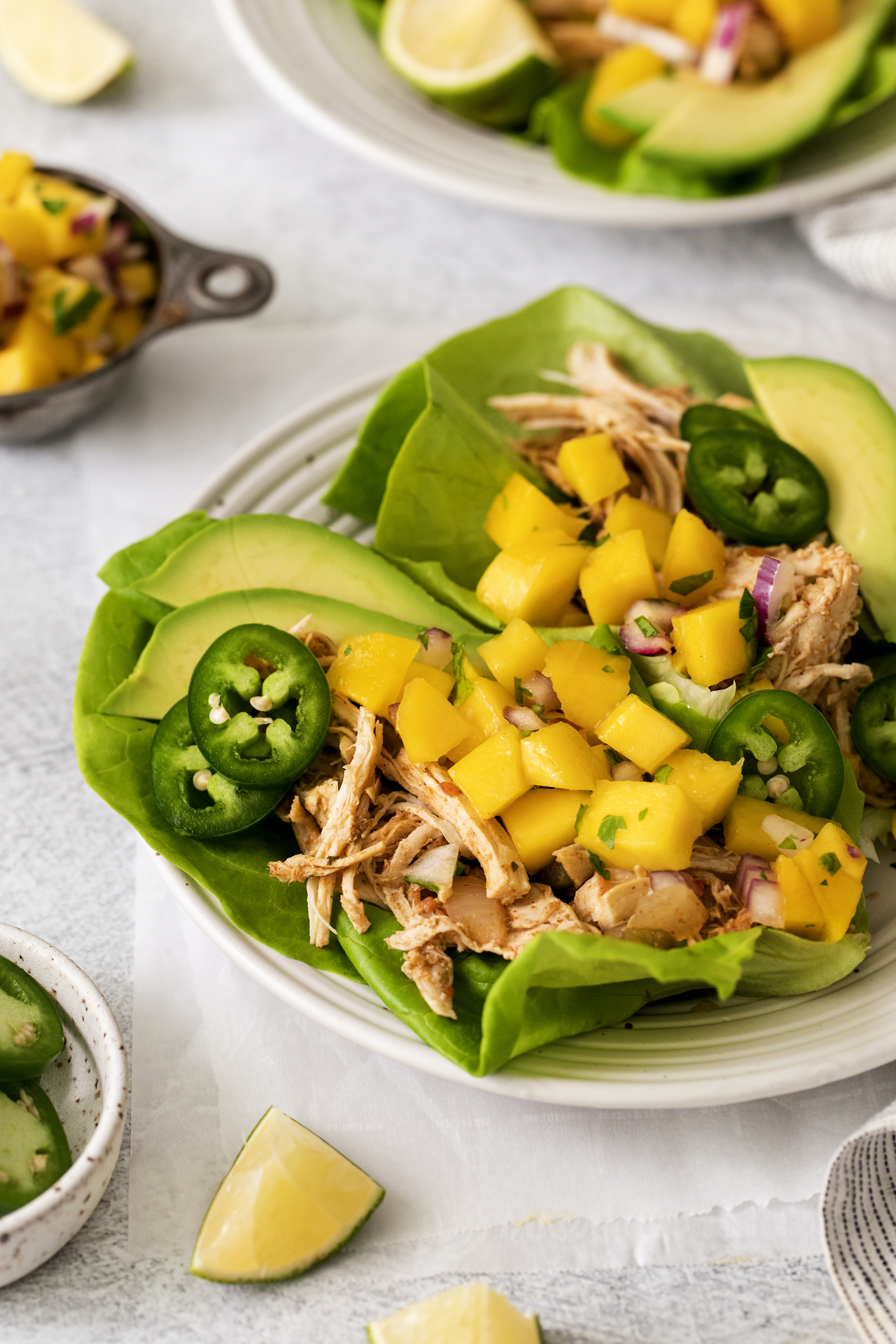 chicken lettuce wraps topped with mango salsa.