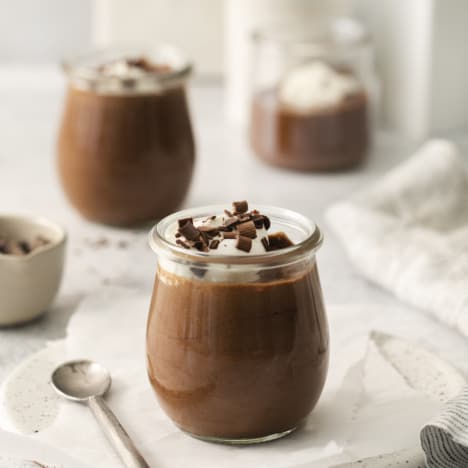 side view of a jar of classic chocolate mousse with others in the background.