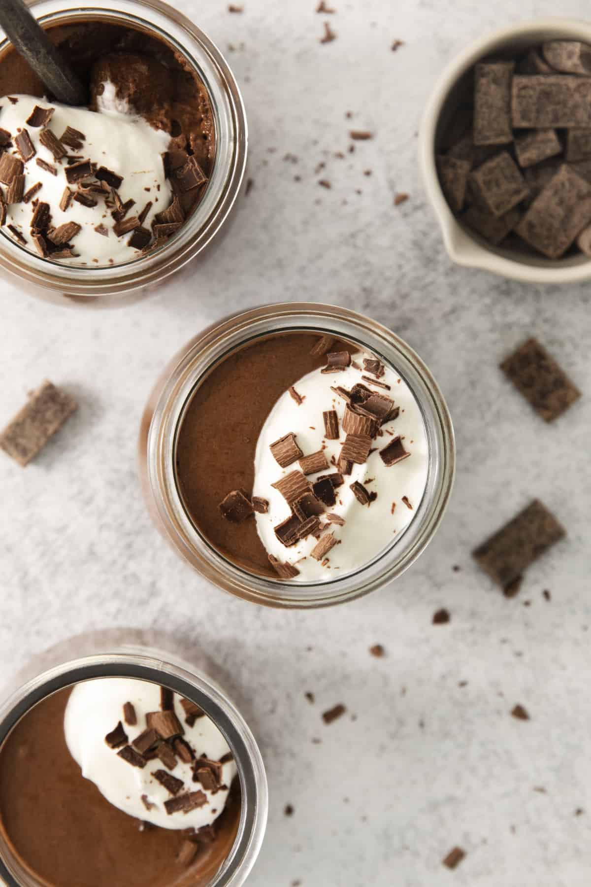 overhead of a jar full of mousse topped with whip.