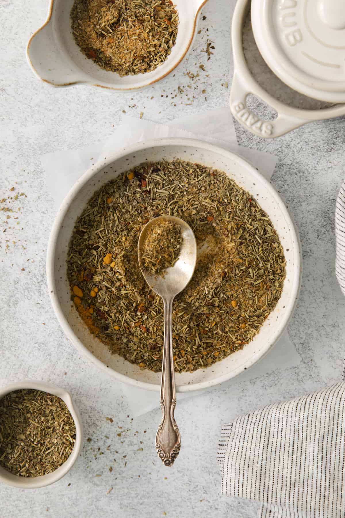 overhead of a bowl of chicken dry rub with a spoon set in the center.