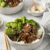 a bowl piled full of slow cooker chicken teriyaki and broccoli.