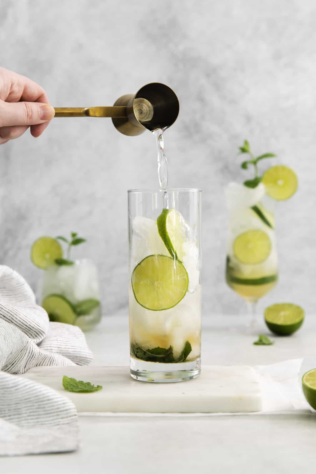 simple syrup being added to a mojito.