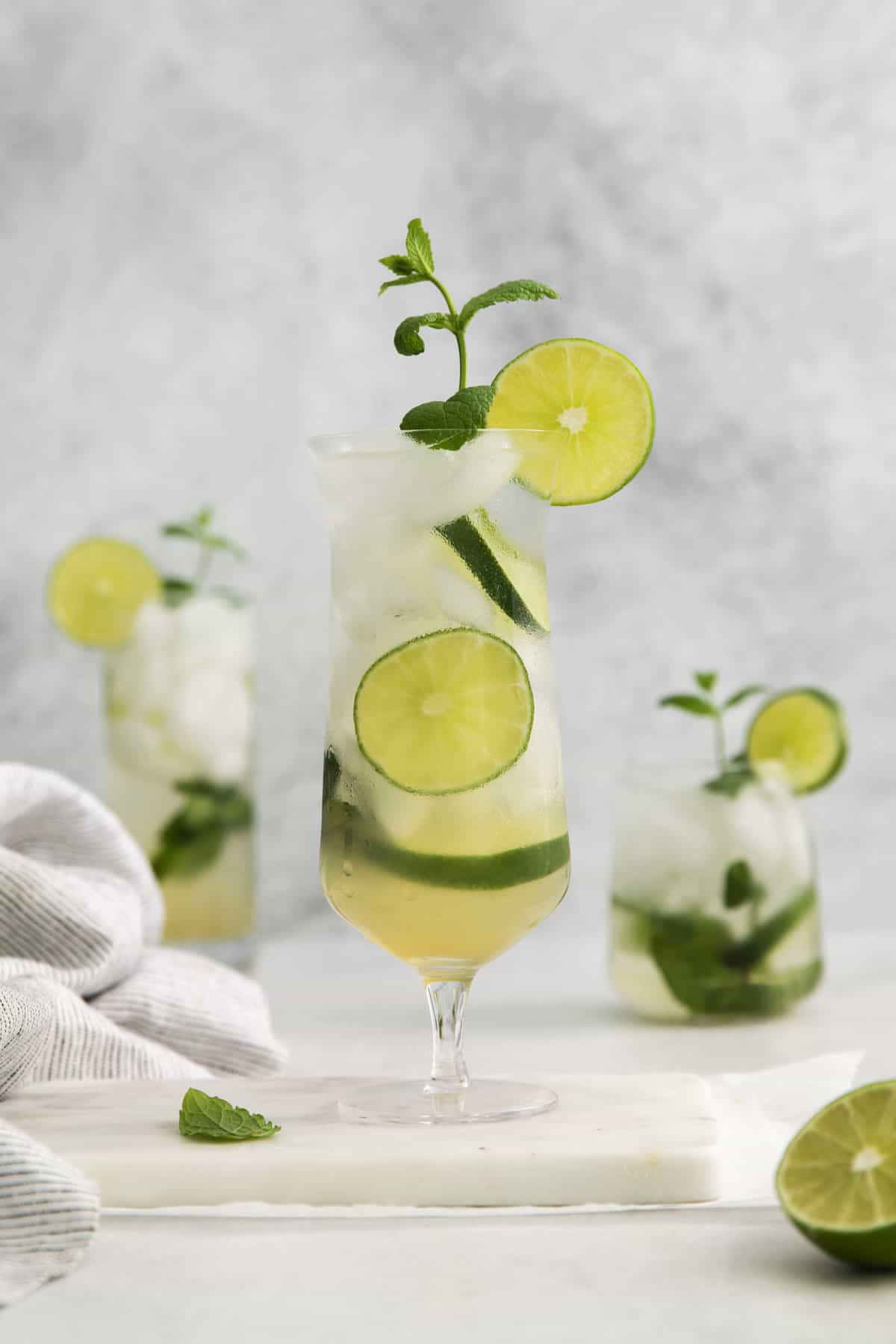 a mojito in a glass with garnishes.