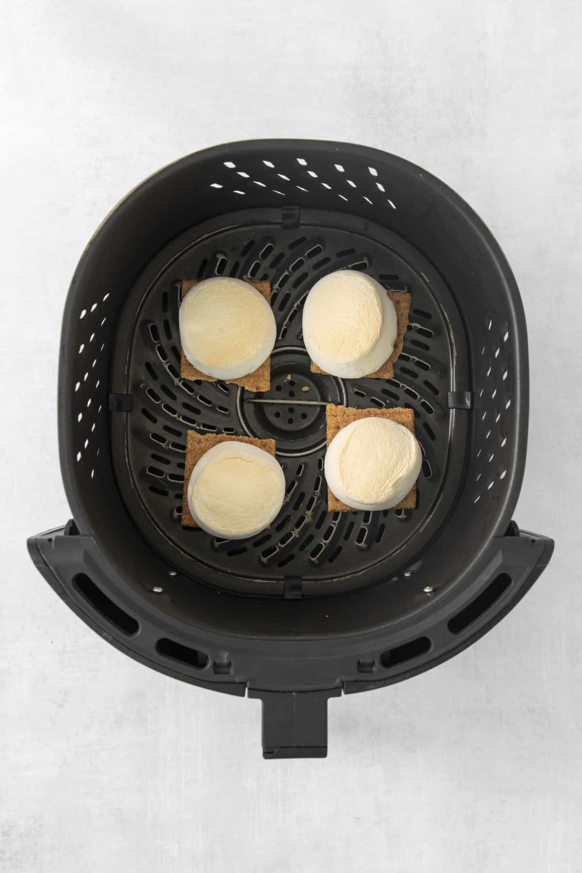 graham crackers topped with toasted marshmallows in the air fryer.