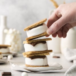 three air fryer s'mores stacked, with the top one being lifted off.